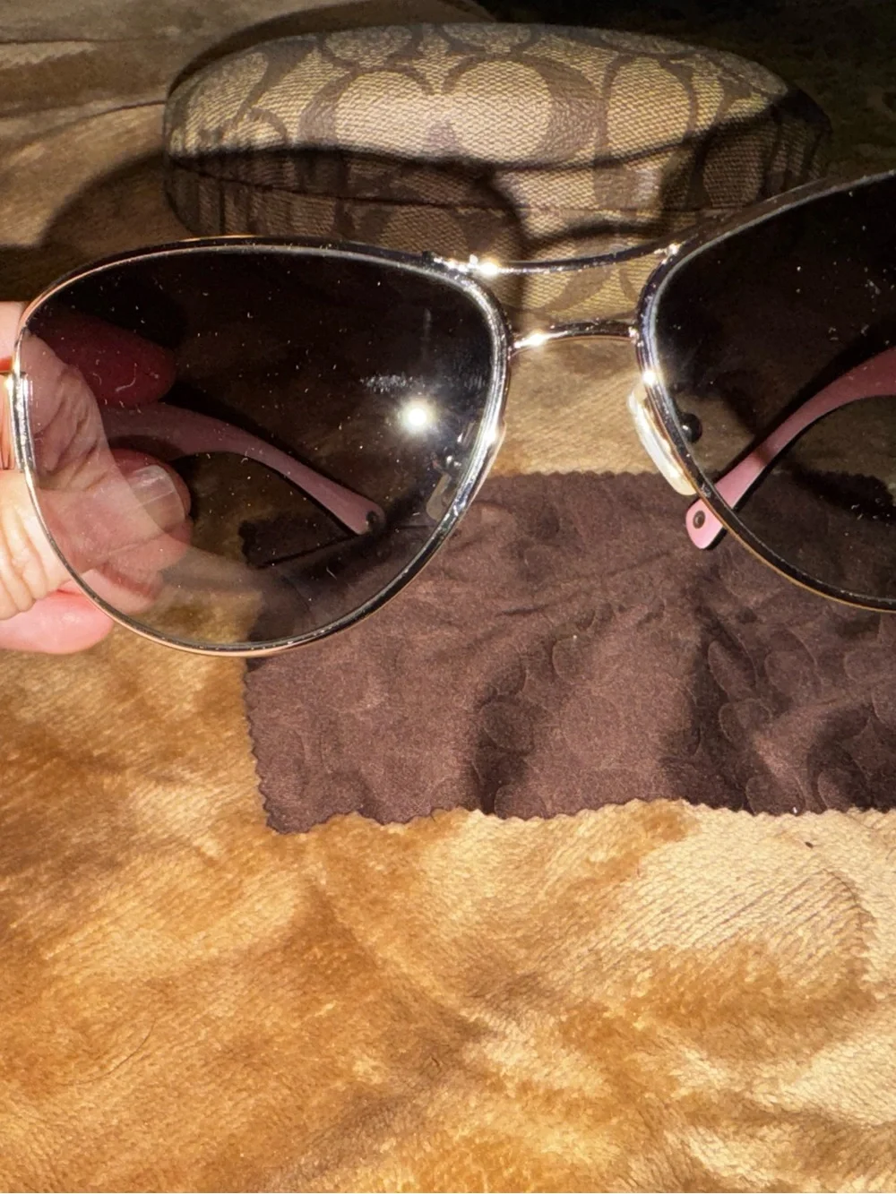 Coach aviator sunglasses with brown lenses and pink temples